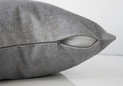 A close-up of the Pillow Square, Insert Included, Decorative Throw, Hypoallergenic shows its gray textured cover with a partially open zipper revealing the white insert against a plain white background.