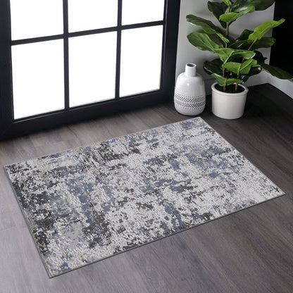 The Payas - Abstract Area Rug, featuring modern blue, gray, and white patterns, rests on a dark wood floor by a large window. Nearby are a potted plant and a white decorative vase.