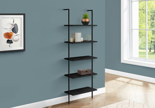 The Etagere Bookcase Ladder 5 Tier for Office, a sleek black metal wall-mounted shelf, holds a potted plant, books, decor items, and a box against a blue wall near a window and abstract art.