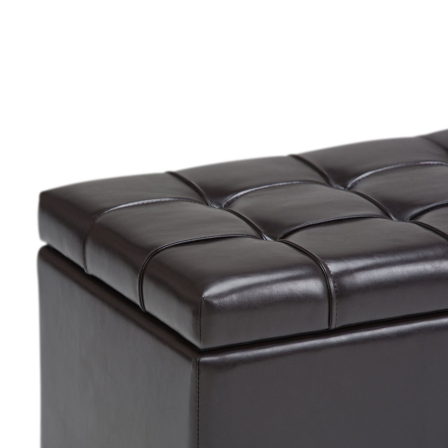 Close-up of the Sienna Upholstered Storage Ottoman Bench in dark brown leather with visible stitching, tufted padded top, and storage space, shown against a white background.