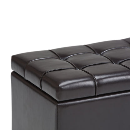Close-up of the Sienna Upholstered Storage Ottoman Bench in dark brown leather with visible stitching, tufted padded top, and storage space, shown against a white background.