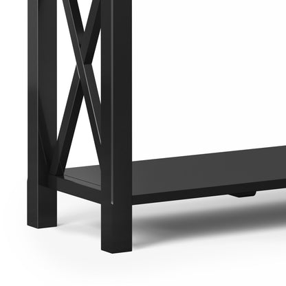 Close-up of the Kitchener - Handcrafted Table’s lower corner, showing its black metal frame with an "X" side design and flat bottom shelf, set against a white background.
