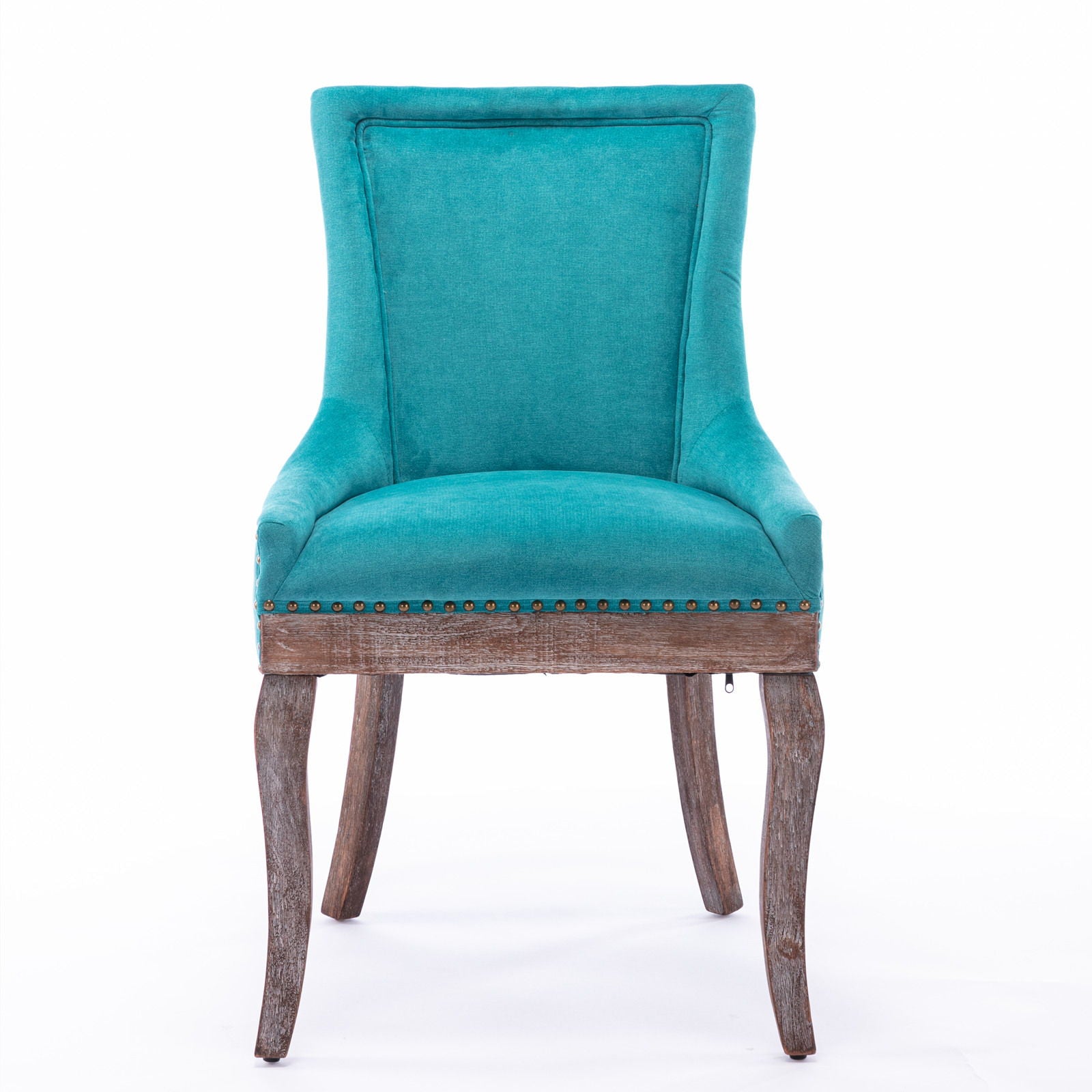 The Ultra Side Dining Chair set features thickened turquoise fabric, a high back, neutrally toned solid wood legs, and bronze nailhead trim, shown against a white background.