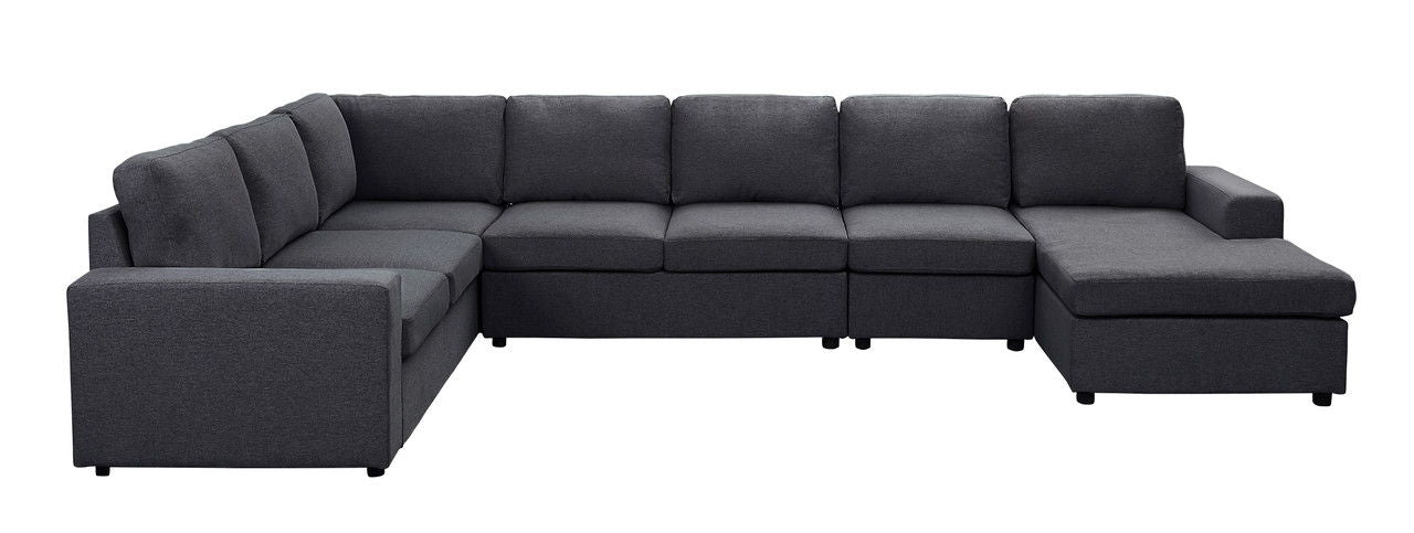 The Hayden - Linen 7 Seat Reversible Modular Sectional Sofa Chaise is a large, dark gray L-shaped sofa with cushions and a right-side chaise lounge, shown against a white background.