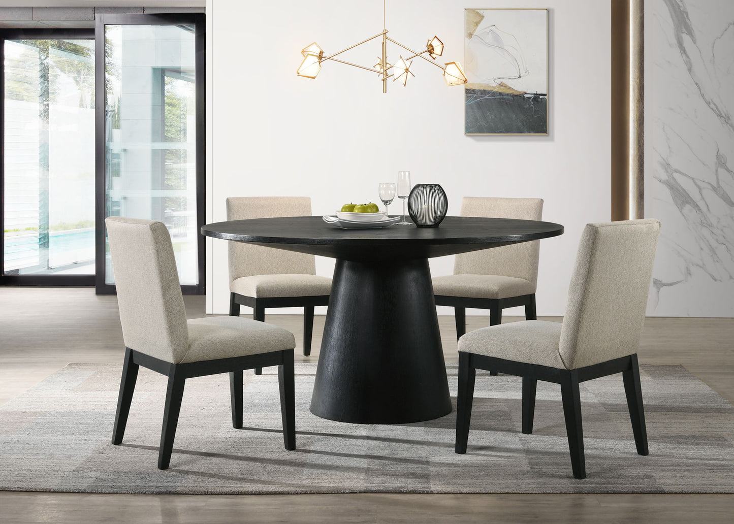 A modern dining room features the Jasper Wide Contemporary Round Dining Table Set with four beige chairs on a gray rug, a geometric chandelier above, abstract wall art, and large windows letting in plenty of natural light.