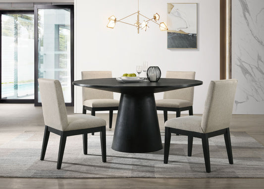 A modern dining room features the Jasper Wide Contemporary Round Dining Table Set with four beige chairs on a gray rug, a geometric chandelier above, abstract wall art, and large windows letting in plenty of natural light.