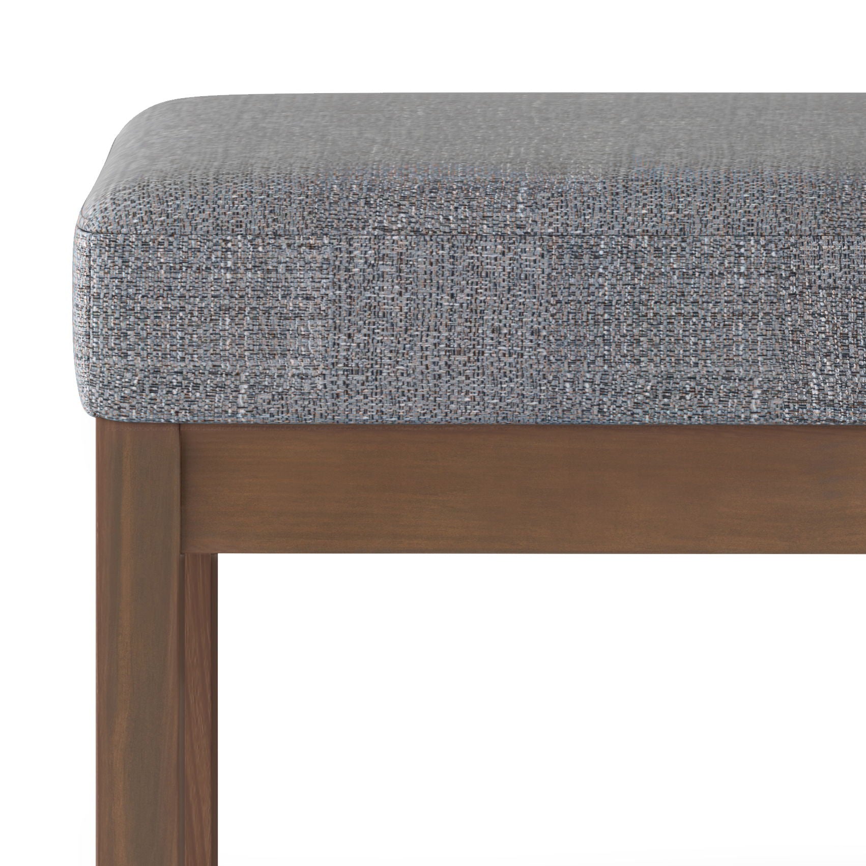 Close-up of the Milltown Upholstered Ottoman Bench, featuring a textured gray cushion and wooden frame, highlighting the fabric and upper part of the legs.