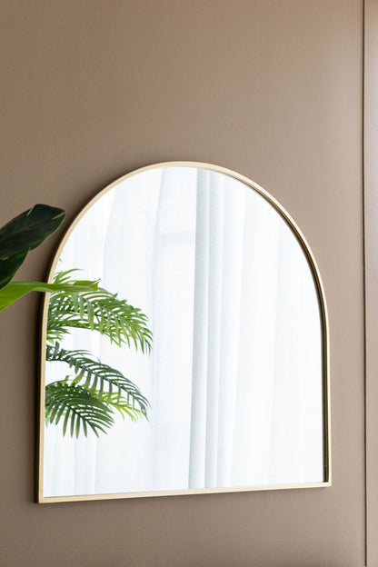 An Arched Mirror With Metal Frame hangs on a beige wall, reflecting a white curtain and part of a green leafy plant—perfect for your living room, bedroom, or entryway.