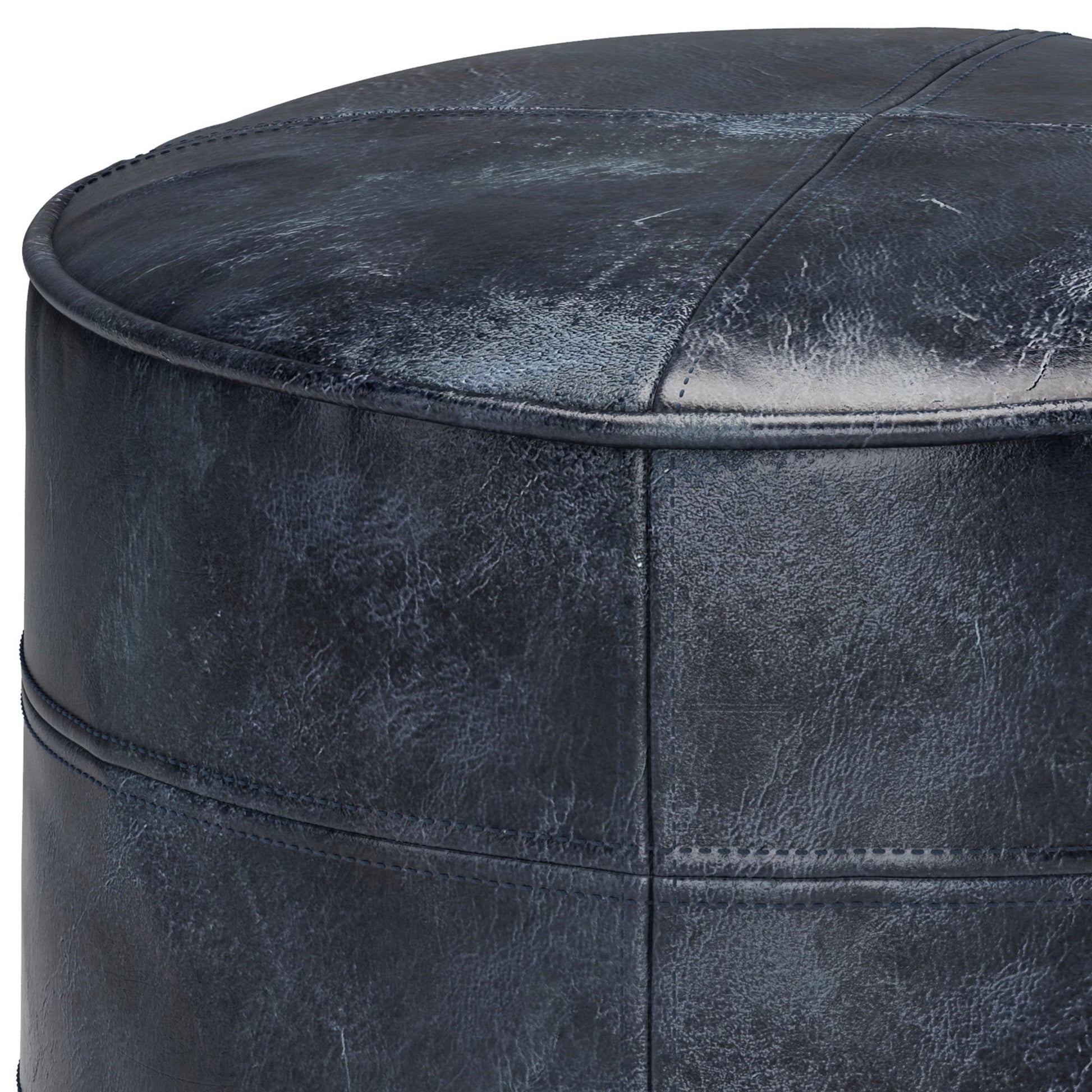 Close-up of the Connor Handcrafted Round Pouf, featuring dark blue leather, visible stitching, and a slightly textured surface.