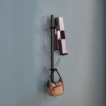 A Vertical Eight Hook Coat Rack Wall Mount in black holds a checkered scarf and a tan handbag against a plain blue wall.
