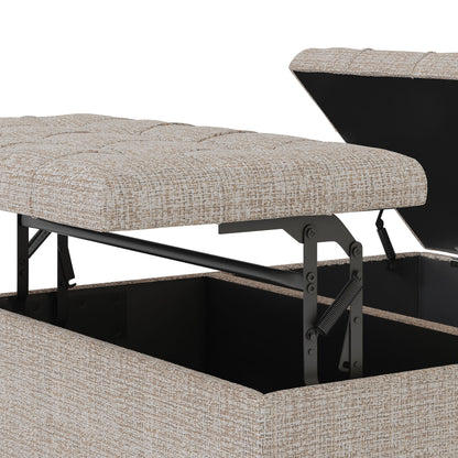 Close-up of the Harrison Upholstered Coffee Table Storage Ottoman in beige fabric, featuring a lift-top mechanism with metal hinges that reveal a spacious inner storage compartment beneath the cushioned top.