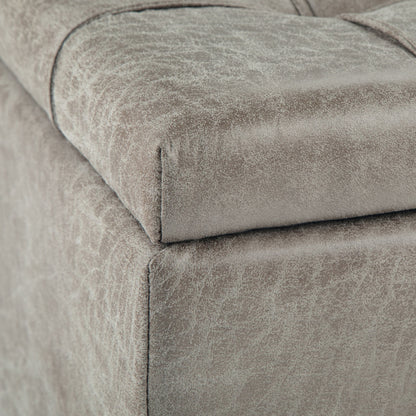 Close-up of the corner of the Harrison Upholstered Coffee Table Storage Ottoman in light gray, showing its textured fabric and detailed stitching.
