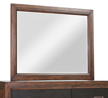 The Couch.com Branson Mirror Rustic Buckeye features a large rectangular design with a wide, dark wood frame in a gray finish. It sits atop a matching dresser and reflects light, though no specific objects are visible in the reflection.