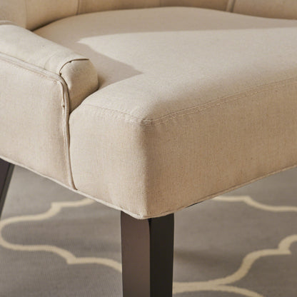 Close-up of the Cheney Contemporary Dining Chair set, featuring beige tufted upholstery and dark wooden legs, displayed on a gray rug with a white geometric pattern.