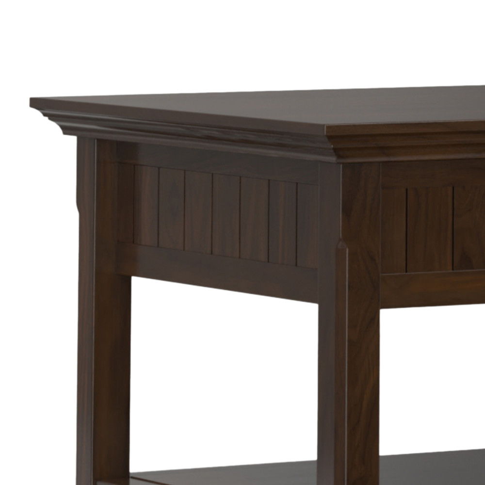 A close-up of the Acadian Lift Top Coffee Table in Brown, showing its dark finish, decorative side paneling, and lower shelf.
