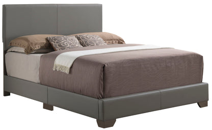 The Elegant Platform Bed For Relaxed Spaces features a tall padded gray headboard, brown and beige bedding, two circular-patterned decorative pillows, and a white throw blanket at the foot.
