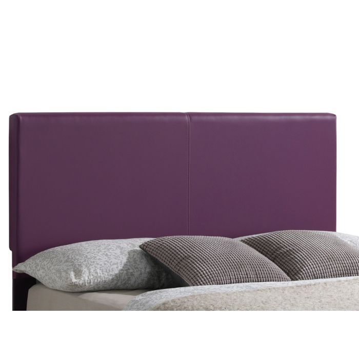 The Elegant Platform Bed For Relaxed Spaces features a tall, rectangular purple upholstered headboard, light bedding, and two patterned pillows.