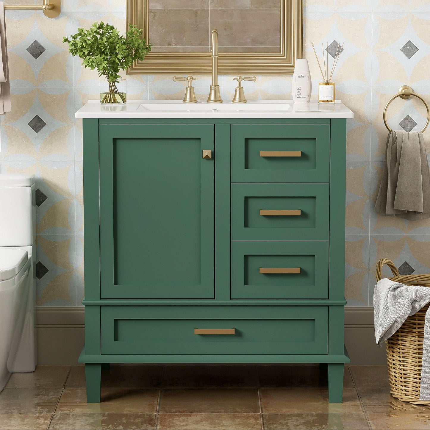 A modern bathroom vanity with a green cabinet, gold handles, white sink, and gold faucet features a solid wood frame, soft closing door, and 3 drawers. It stands on brown tile flooring with towels, a wicker basket, and a mirror above.