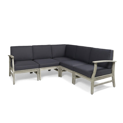 The Perla - 5 Pieces Sofa Set is a gray L-shaped outdoor sectional with a wooden frame, dark gray cushions, armrests on both ends, and seating for at least five people.