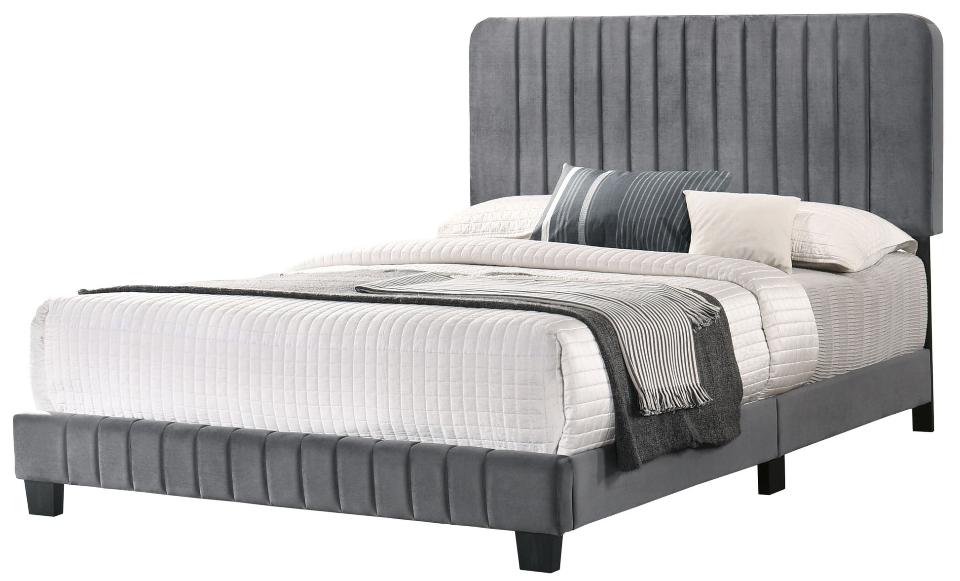 The Lodi - Bed features a tall, vertically paneled gray upholstered headboard, matching frame, white quilted bedding, multiple pillows, and a folded gray blanket at the foot for a modern look.