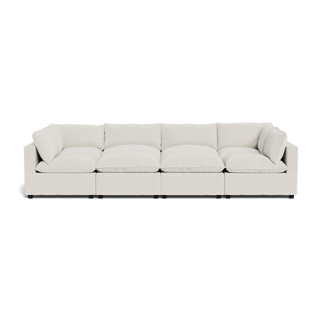 The Kova Pillow Cushion Grand Pit is a large, modern light beige sectional sofa featuring five seat cushions plus matching backrest and side cushions, shown from the front against a white background.