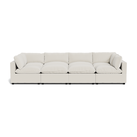 The Kova Pillow Cushion Grand Pit is a large, modern light beige sectional sofa featuring five seat cushions plus matching backrest and side cushions, shown from the front against a white background.