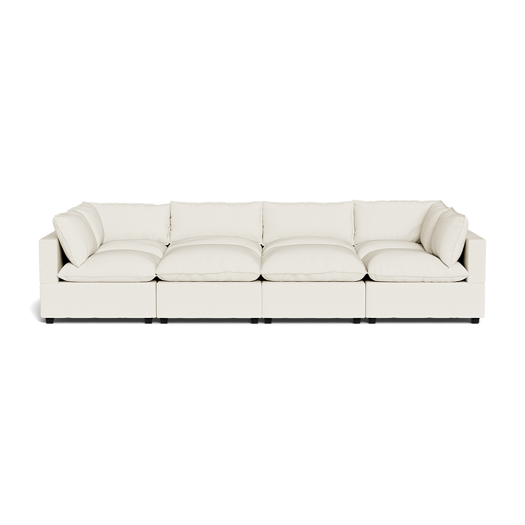 The Kova Pillow Cushion Grand Pit is a large, modern sectional sofa in cream with plush seat and back cushions, minimalist rectangular design, and seating for at least five—shown against a plain black background.