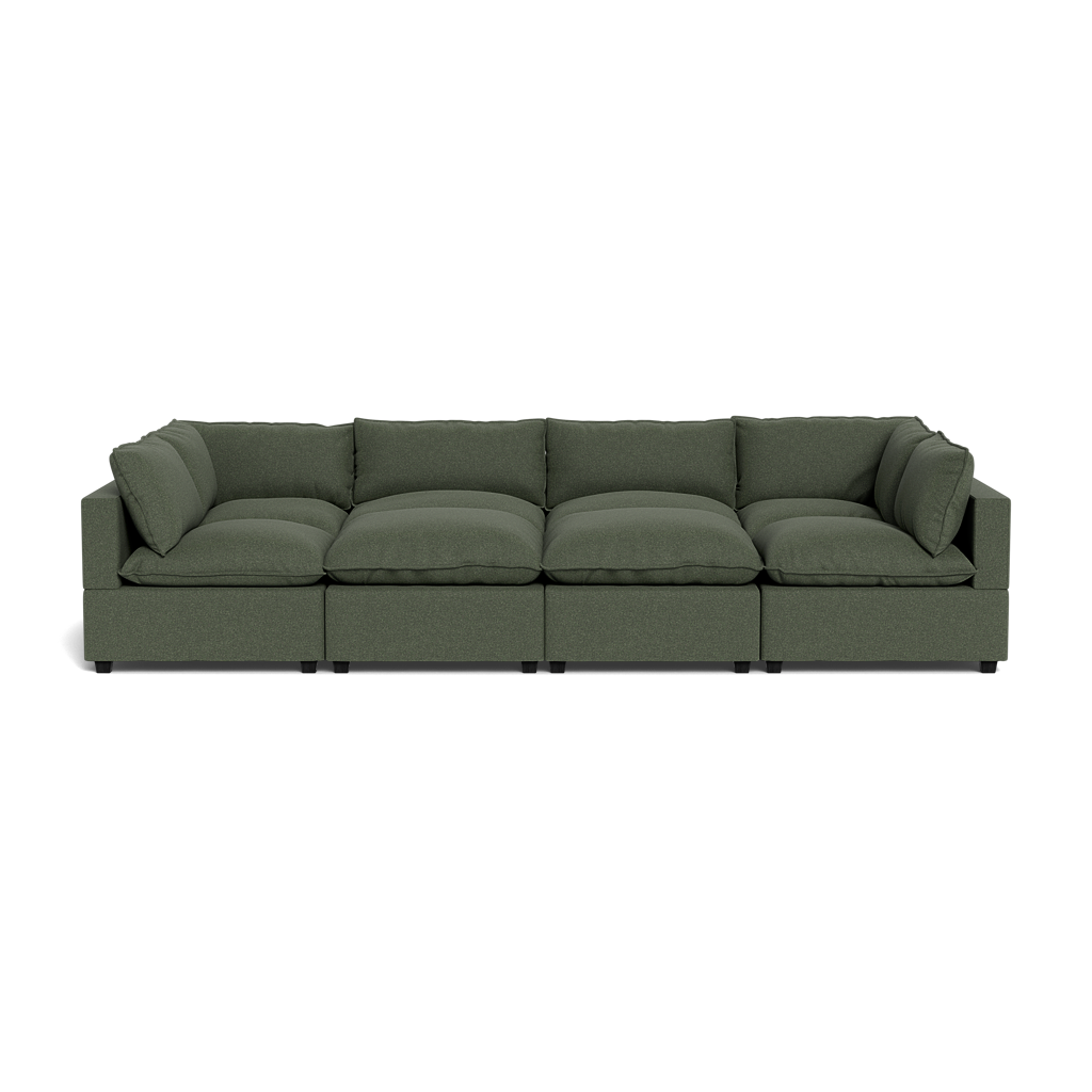 The Kova Pillow Cushion Grand Pit is a modern, dark green sectional sofa featuring five seat cushions and matching back and side pillows, shown from the front against a plain black background.