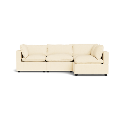 The Kova Pillow Cushion L-Shape is a modern beige sectional sofa with three seat cushions, a right-side chaise lounge, and four backrest cushions, shown isolated on a white background.