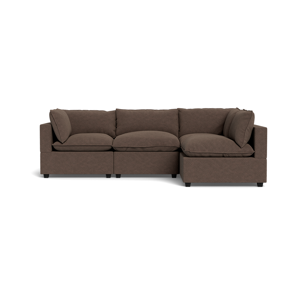 The Kova Pillow Cushion L-Shape, shown from the front against a plain black background, features a brown L-shaped design with three seat cushions, three back cushions, and two armrest pillows.