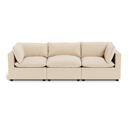 The Kova Pillow Cushion Sofa 122" is a modern, light beige sofa with three seat cushions and five matching back and side pillows, shown from the front against a plain background.