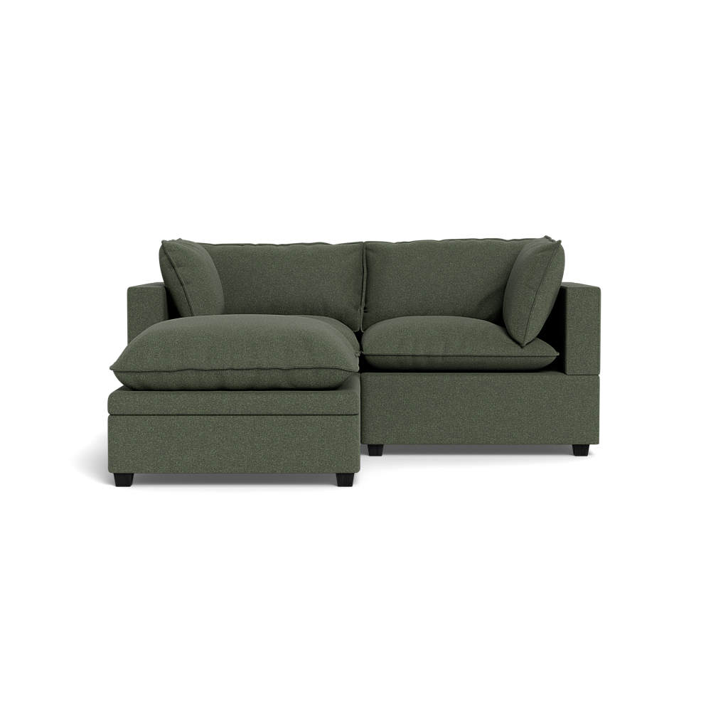 The Kova Pillow Cushion Sofa 86" with ottoman is a modern green sectional featuring plush cushions, a left-side chaise lounge, and square armrests, displayed against a plain black background.