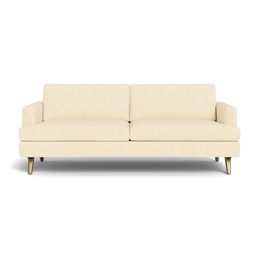 The Lido Sofa 75" is a modern light beige sofa featuring two seat and back cushions, slim armrests, and short angled wooden legs, set against a plain black background.