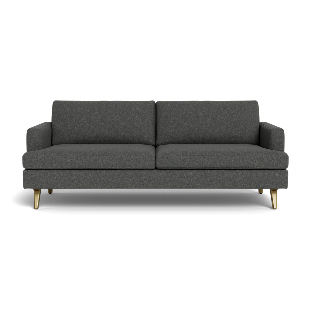 The Lido Sofa 75" is a modern dark gray fabric sofa featuring square armrests, two seat and back cushions, plus angled wooden legs with brass tips, displayed against a black background.