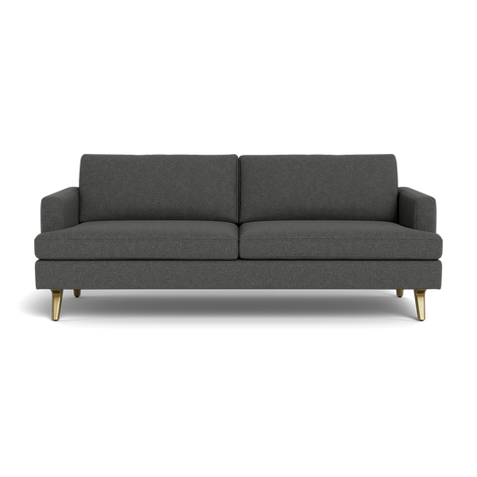 The Lido Sofa 75" is a modern dark gray fabric sofa featuring square armrests, two seat and back cushions, plus angled wooden legs with brass tips, displayed against a black background.