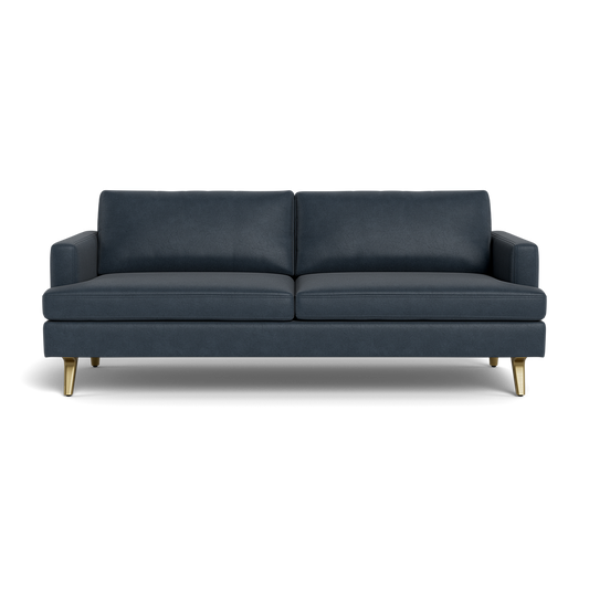 The Lido Sofa 75" is a modern dark blue sofa featuring two seat and back cushions, square arms, and four angled gold legs, shown from the front against a plain background.
