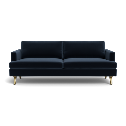 The Lido Sofa 75" is a modern dark blue velvet sofa featuring two seat cushions, two back cushions, slim armrests, and four angled gold legs, displayed against a plain black background.