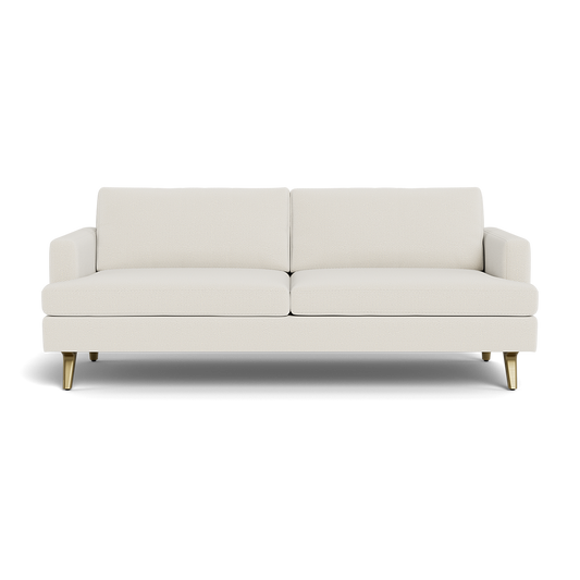 The Lido Sofa 75" is a modern, cream-colored piece featuring straight lines, two seat and back cushions, slim armrests, and four wooden legs with gold accents, shown against a plain black background.