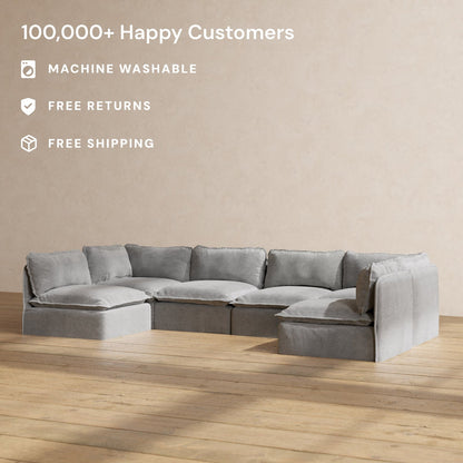 The Modular Performance 6-Seater Open-Ends U-Sectional Plush Weave Ash is placed on a wooden floor against a plain beige wall. Text highlights "100,000+ Happy Customers," "Machine Washable," "Free Returns," and "Free Shipping.