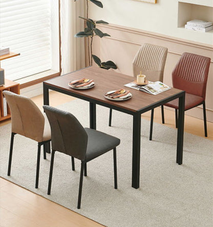 A modern dining table with a wood top and black legs is set for two, surrounded by four Dining Chairs Living Room Chair Modern Kitchen Armless Side Chair With Metal Legs on a light beige rug in a bright, minimalist room.