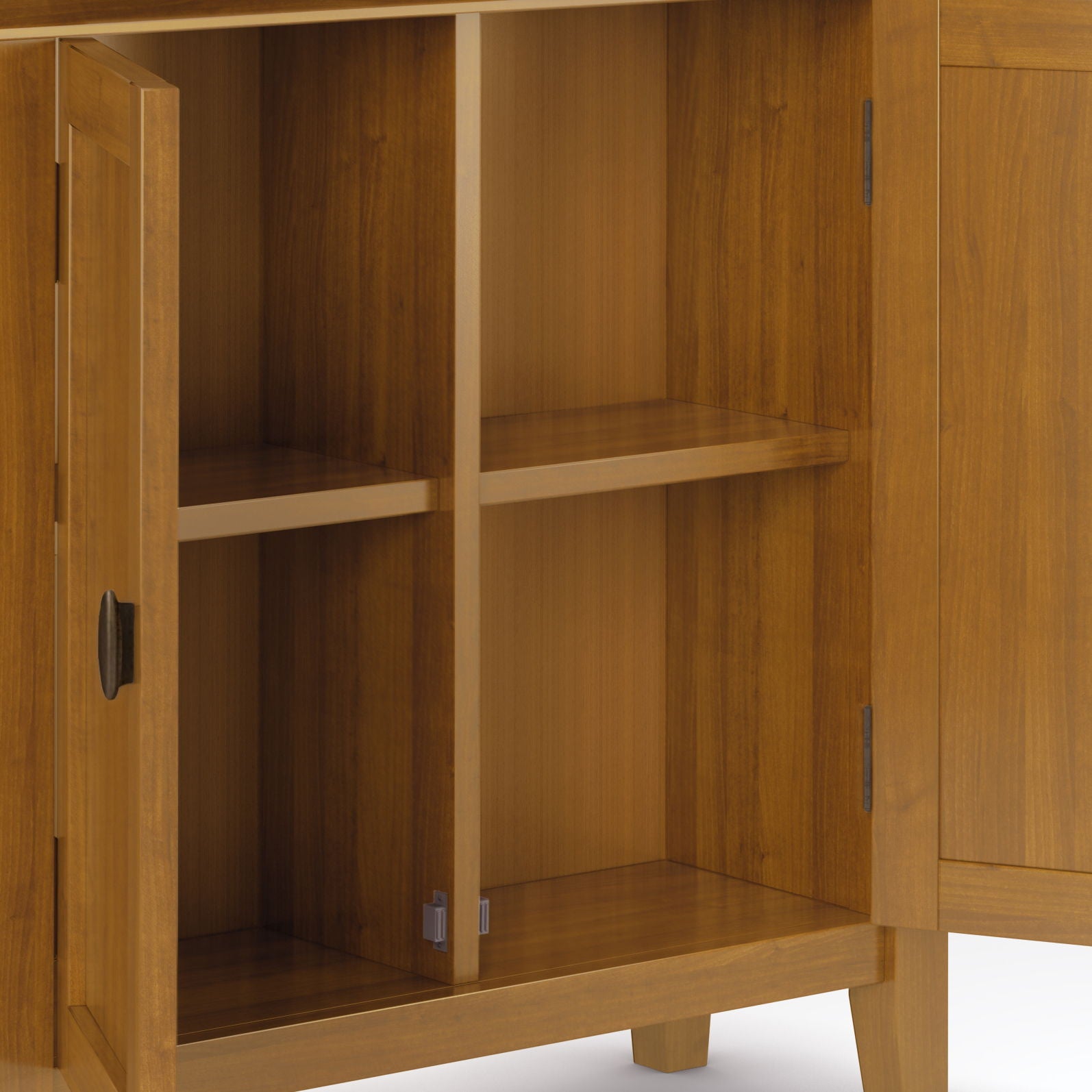 The Redmond Handcrafted Low Storage Cabinet features two doors that open to reveal four empty shelves. Finished in warm, light brown wood, this cabinet stands on short legs for a sturdy, stylish look.