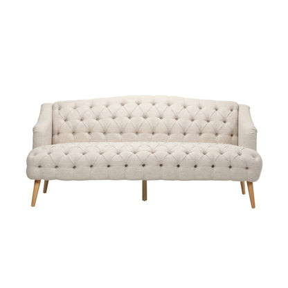 The Comfy 3 Seat Sofa with wooden legs, designed for living rooms and studies, features a beige tufted finish and curved armrests, set against a white background.