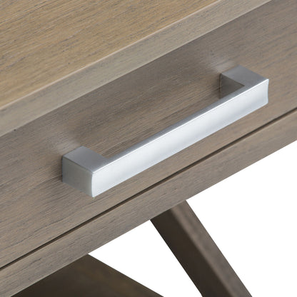 Close-up of the Kitchener - Handcrafted Table’s wooden drawer with a light brown finish and a rectangular, metallic silver handle featuring a modern, minimalist design.