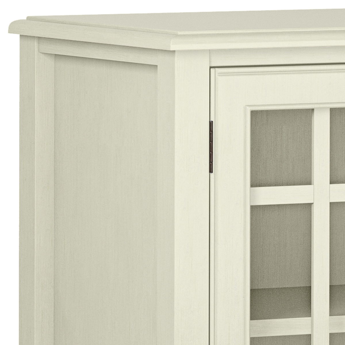 A close-up of the upper left corner of the Connaught - Handcrafted Low Storage Cabinet, showing its light wood finish, smooth top, glass-panel door with grid design, and simple classic style.