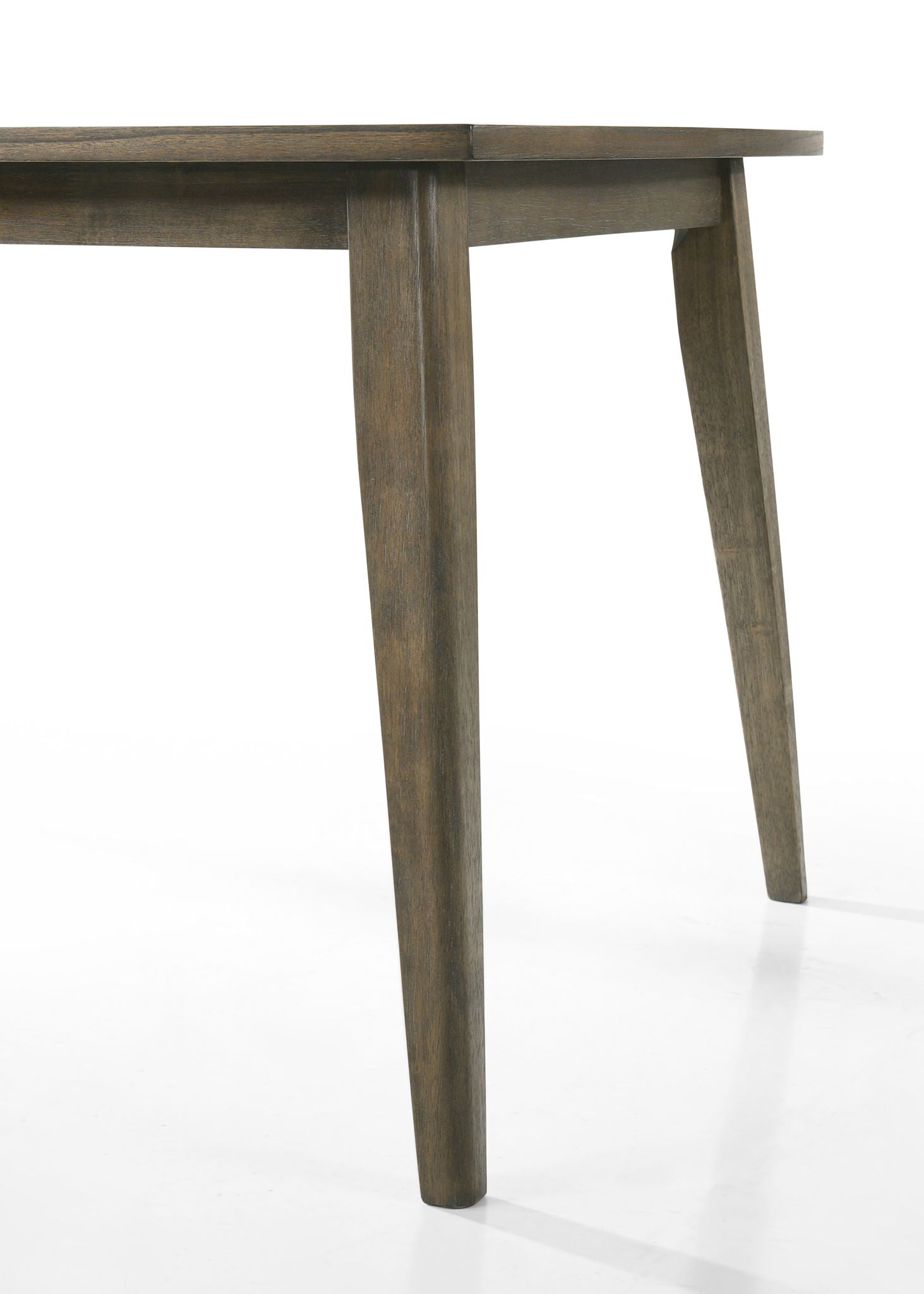 A close-up view of the corner of the Bistro Dining Table with tapered legs and a smooth finish, paired with off white fabric dining chairs, photographed on a white background.