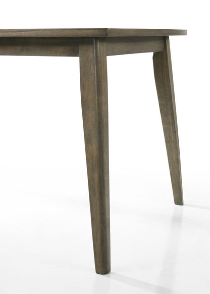 A close-up view of the corner of the Bistro Dining Table with tapered legs and a smooth finish, paired with off white fabric dining chairs, photographed on a white background.