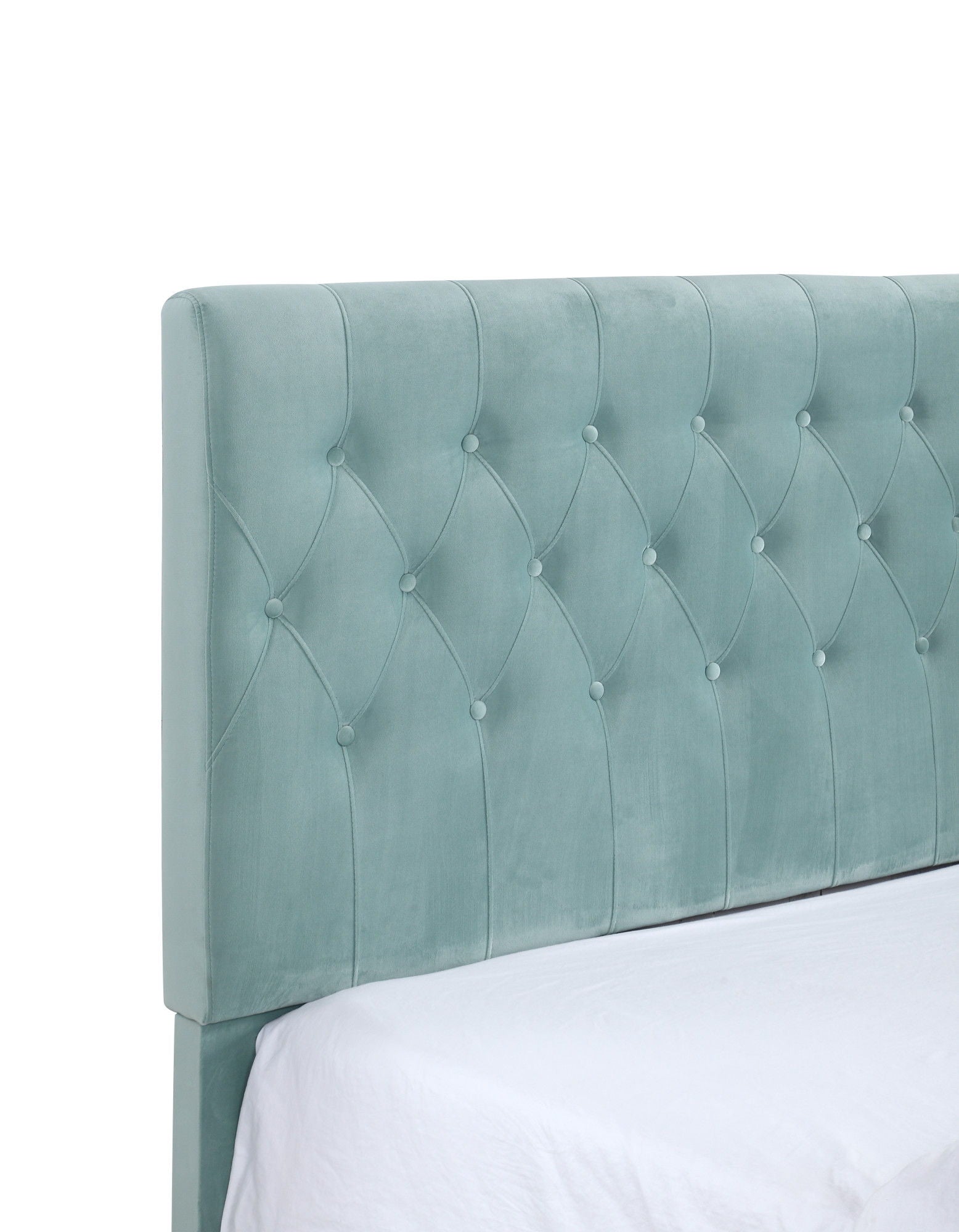 The Luma - Upholstered Bed features a light teal, tufted fabric headboard with button detailing, diamond-pattern stitching, and a soft padded look. Shown attached to a bed with a white sheet.