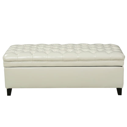 The Juliana Storage Ottoman features white tufted leather and short black birch legs, displayed from the front against a plain background.