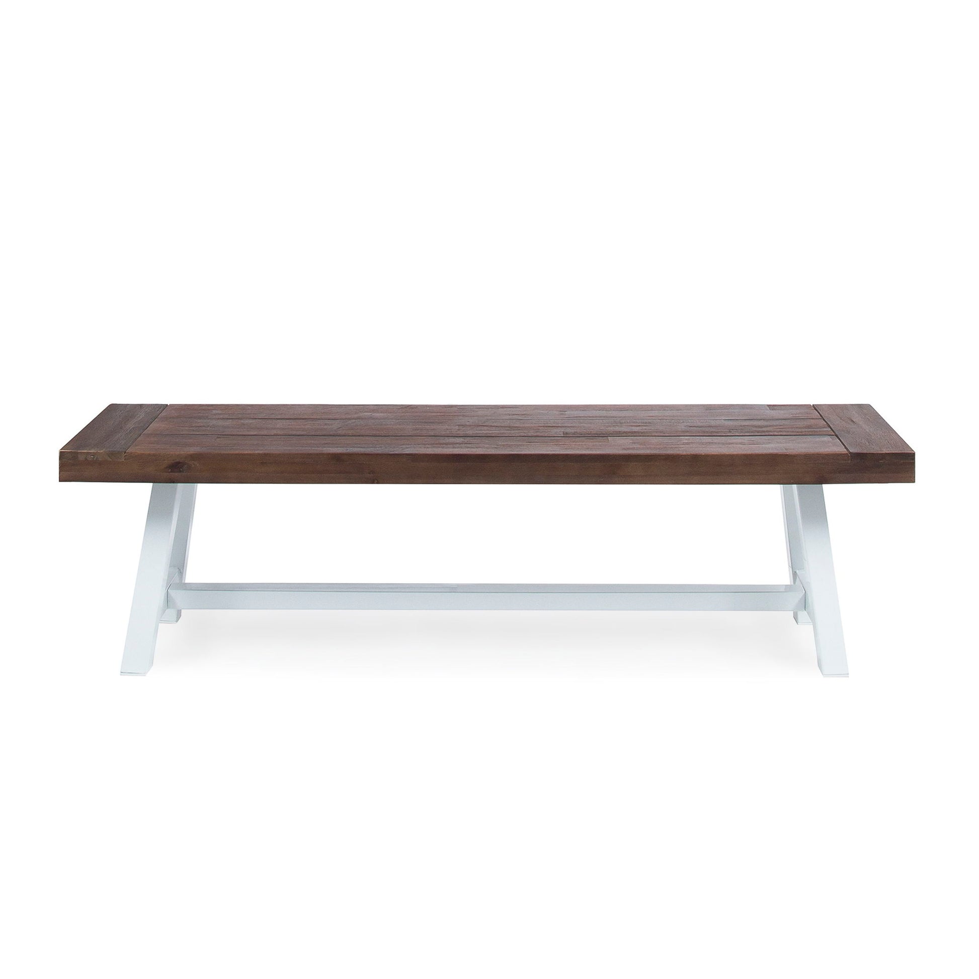 The Tranquilizer outdoor bench features a rectangular acacia wood build with a slat panel design and dark brown finish, complemented by white angled legs, displayed against a plain white background.