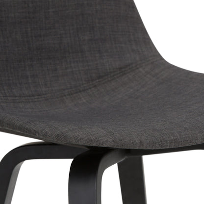 Close-up of the Randolph Bentwood Counter / Bar Height Stool, featuring a curved dark grey upholstered seat and backrest with black wooden legs.